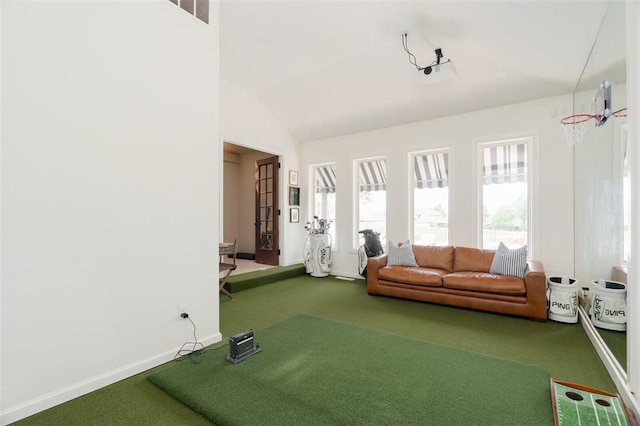 carpeted living room featuring baseboards and lofted ceiling