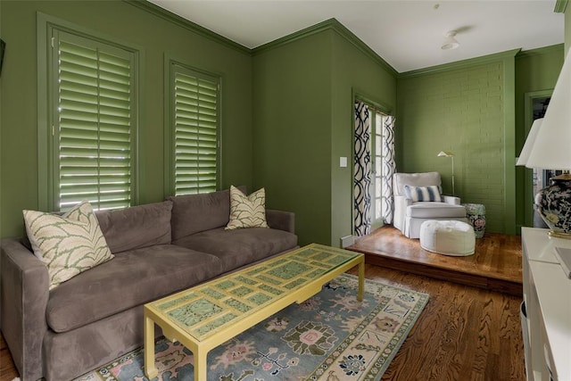 living room with ornamental molding and wood finished floors