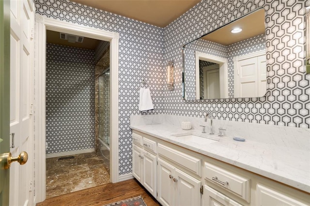 bathroom with an enclosed shower and vanity