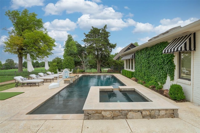 view of swimming pool featuring a fenced in pool, fence, a patio, and an in ground hot tub