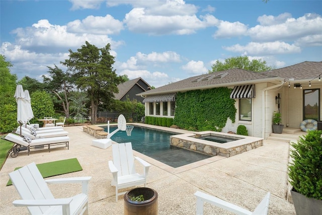outdoor pool with a patio and an in ground hot tub