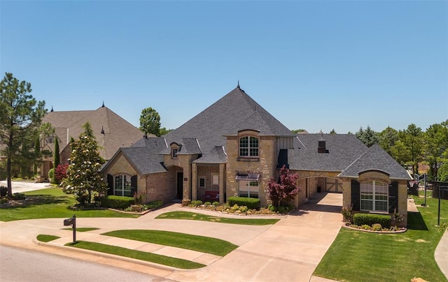 4301 Frisco Bridge Blvd, Edmond, OK 73034 - french country inspired facade featuring concrete driveway, stone siding, and a shingled roof