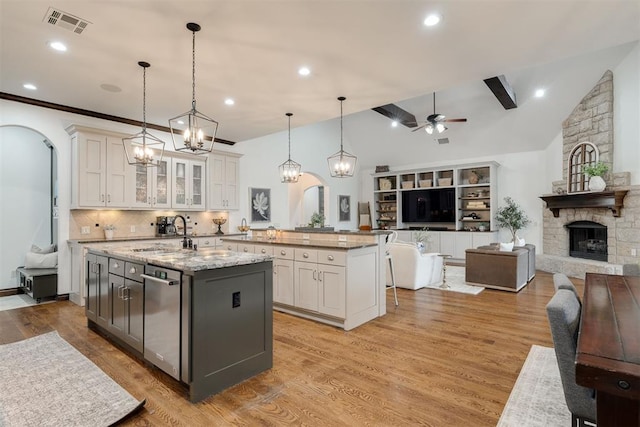 4301 Frisco Bridge Blvd, Edmond, OK 73034 - kitchen with open floor plan, arched walkways, a ceiling fan, lofted ceiling, and white cabinetry