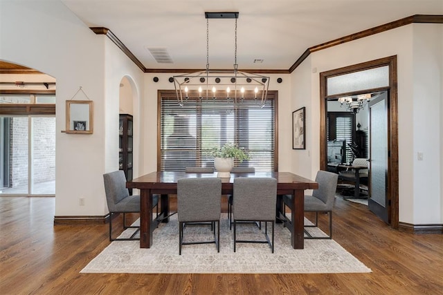 4301 Frisco Bridge Blvd, Edmond, OK 73034 - dining area with a chandelier, arched walkways, baseboards, ornamental molding, and wood finished floors
