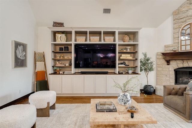 4301 Frisco Bridge Blvd, Edmond, OK 73034 - living room featuring wood finished floors, vaulted ceiling, and a fireplace