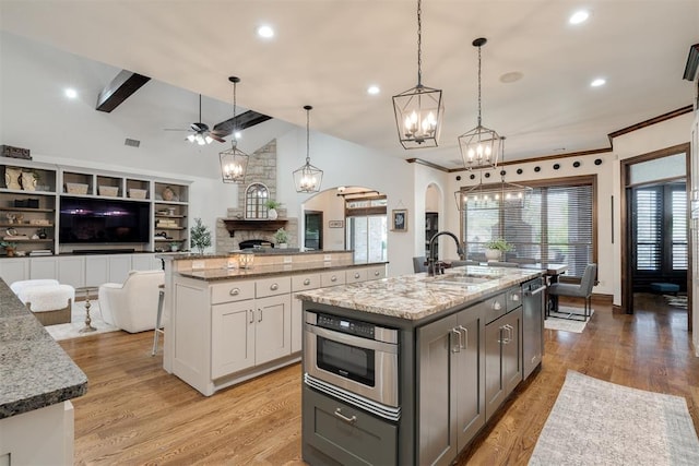4301 Frisco Bridge Blvd, Edmond, OK 73034 - kitchen with a sink, open floor plan, arched walkways, a spacious island, and a chandelier