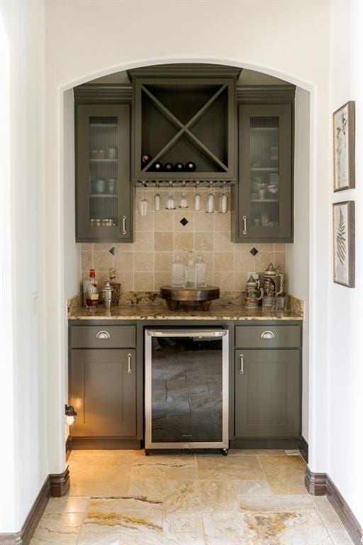 4301 Frisco Bridge Blvd, Edmond, OK 73034 - indoor wet bar with beverage cooler, baseboards, and tasteful backsplash