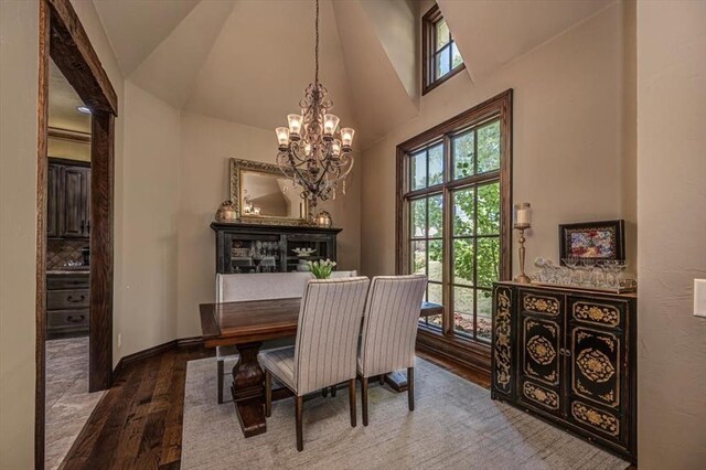 4400 The Ranch Rd, Edmond, OK 73034 - dining space with wood finished floors, high vaulted ceiling, a notable chandelier, and baseboards