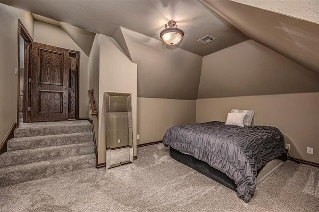 4400 The Ranch Rd, Edmond, OK 73034 - bedroom with visible vents, vaulted ceiling, carpet, and baseboards
