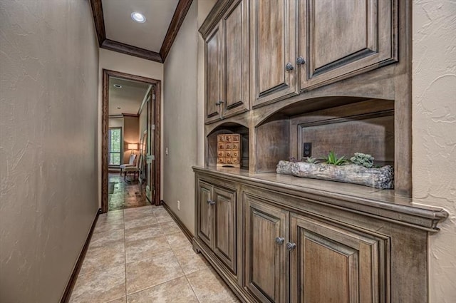 4400 The Ranch Rd, Edmond, OK 73034 - hallway with baseboards, ornamental molding, light tile patterned flooring, and a textured wall
