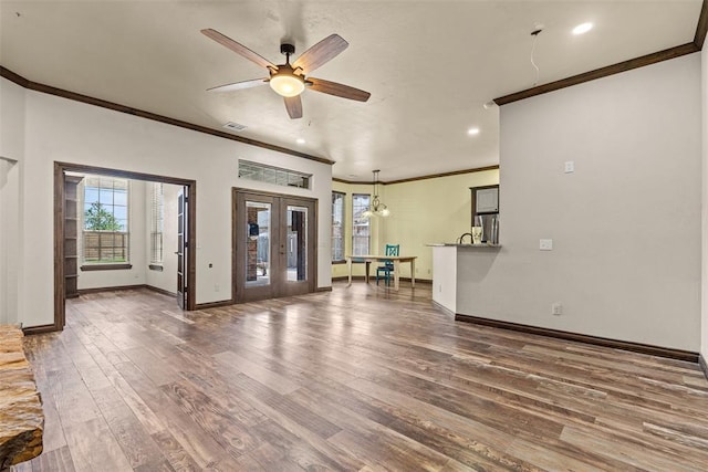212 SW 144th, Oklahoma City, OK 73170 - unfurnished living room with crown molding, wood finished floors, plenty of natural light, a ceiling fan, and baseboards
