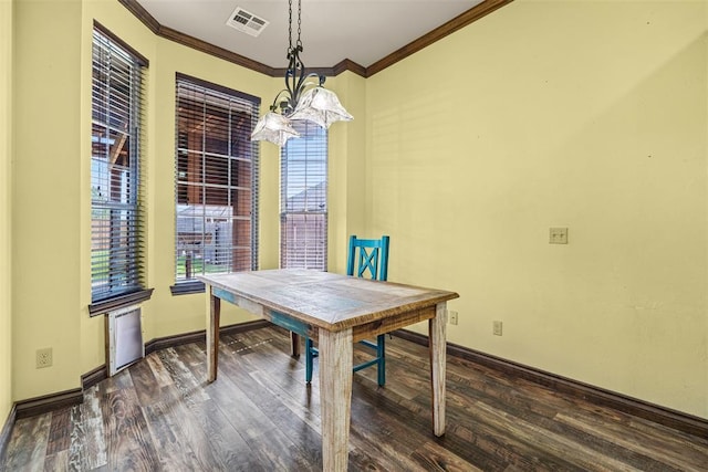 212 SW 144th, Oklahoma City, OK 73170 - dining area with crown molding, dark wood-type flooring, baseboards, and a chandelier