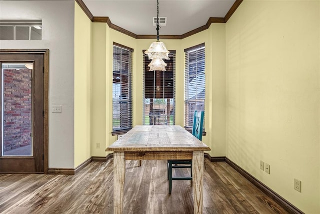 212 SW 144th, Oklahoma City, OK 73170 - dining room featuring dark wood-style flooring, baseboards, ornamental molding, and a chandelier