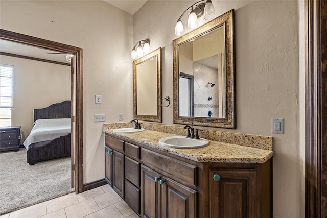 212 SW 144th, Oklahoma City, OK 73170 - ensuite bathroom featuring tile patterned flooring, a textured wall, double vanity, and baseboards