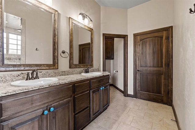 212 SW 144th, Oklahoma City, OK 73170 - bathroom with baseboards, double vanity, and tile patterned flooring
