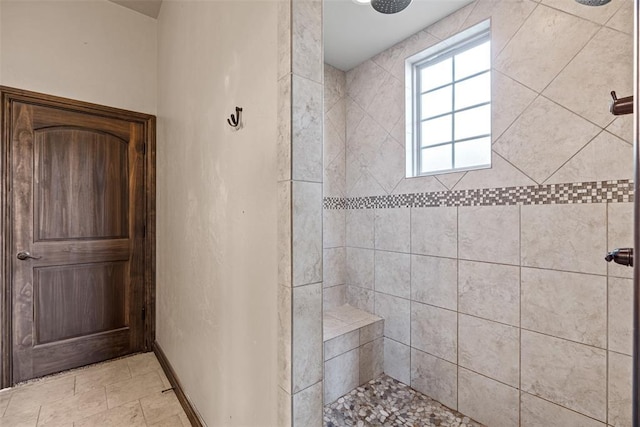 212 SW 144th, Oklahoma City, OK 73170 - bathroom featuring a tile shower and baseboards