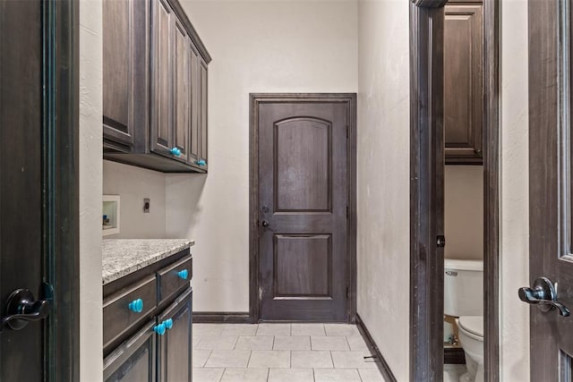212 SW 144th, Oklahoma City, OK 73170 - clothes washing area featuring electric dryer hookup, light tile patterned floors, baseboards, cabinet space, and washer hookup