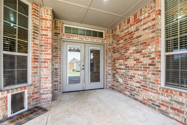 212 SW 144th, Oklahoma City, OK 73170 - doorway to property with french doors, brick siding, and a porch