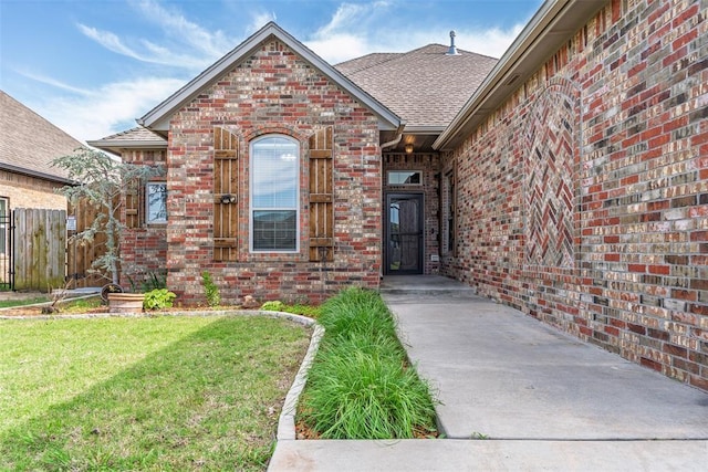 212 SW 144th, Oklahoma City, OK 73170 - view of exterior entry with brick siding and a shingled roof