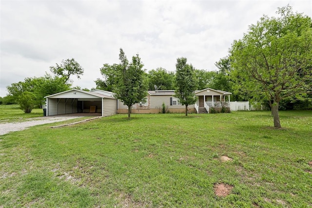 view of yard with a porch, driveway, and a carport
