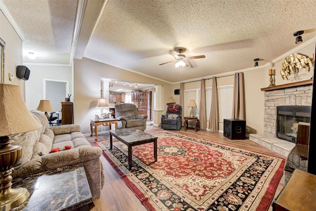 living area featuring ornamental molding, a ceiling fan, and wood finished floors