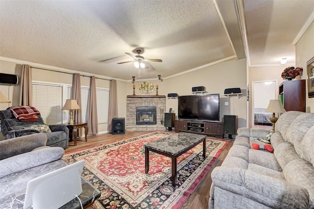 living area with a textured ceiling, ceiling fan, ornamental molding, and wood finished floors