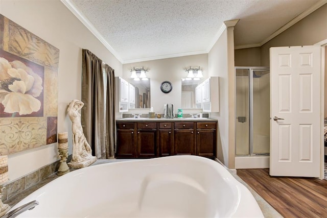 full bathroom with ornamental molding, a bath, and a stall shower