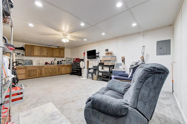 living room featuring recessed lighting, a ceiling fan, light colored carpet, and electric panel