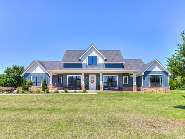 3345 Red Ridge Dr, Blanchard, OK 73010 - view of front of home featuring a porch, a front lawn, a shingled roof, and board and batten siding
