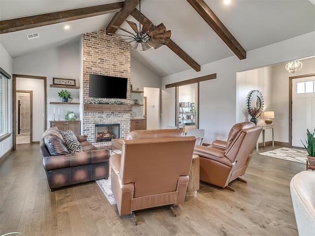 3345 Red Ridge Dr, Blanchard, OK 73010 - living room with light wood-type flooring, beamed ceiling, a ceiling fan, a brick fireplace, and high vaulted ceiling