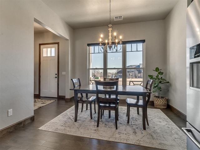 3345 Red Ridge Dr, Blanchard, OK 73010 - dining room featuring a chandelier, baseboards, and dark wood-type flooring