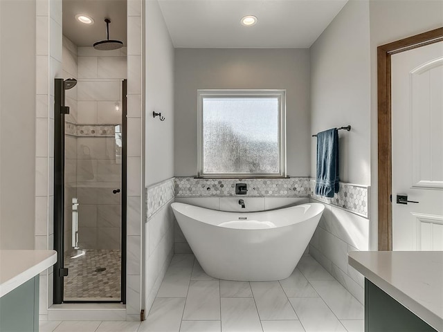 3345 Red Ridge Dr, Blanchard, OK 73010 - full bath featuring tile walls, a stall shower, a freestanding bath, a wainscoted wall, and recessed lighting