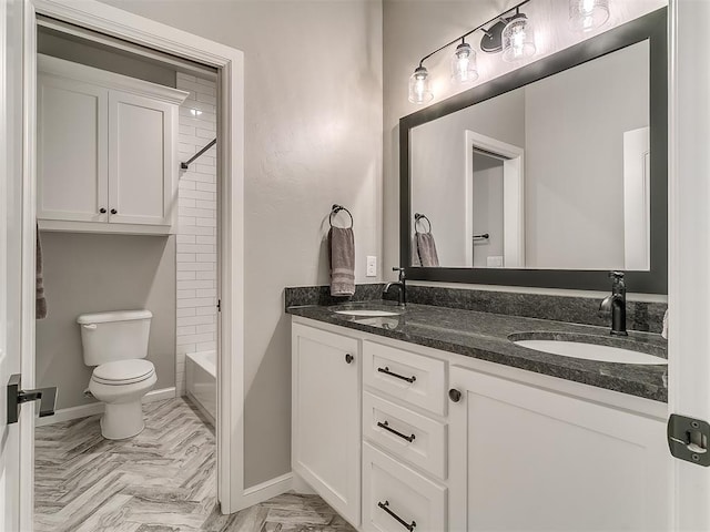 3345 Red Ridge Dr, Blanchard, OK 73010 - bathroom featuring toilet, double vanity, baseboards, and bathtub / shower combination