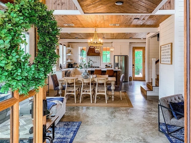 dining area featuring finished concrete floors, wood ceiling, a notable chandelier, and visible vents