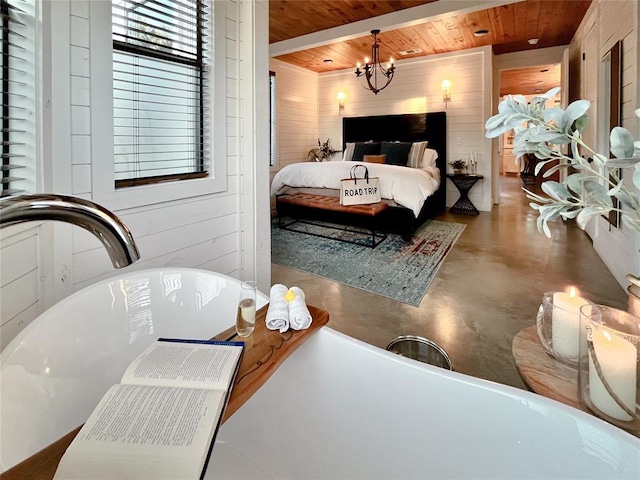 bedroom with a chandelier, wood walls, wooden ceiling, and finished concrete flooring