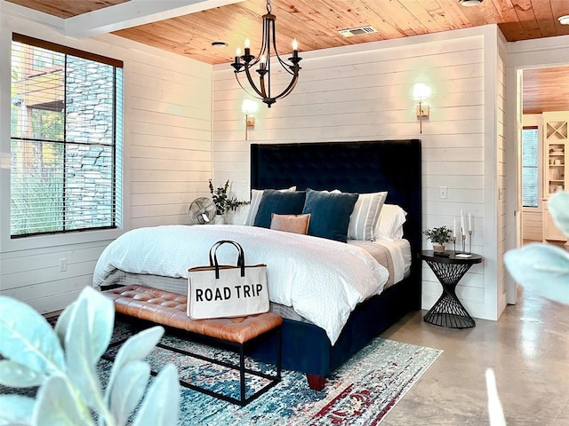bedroom featuring wooden walls, wood ceiling, and concrete flooring
