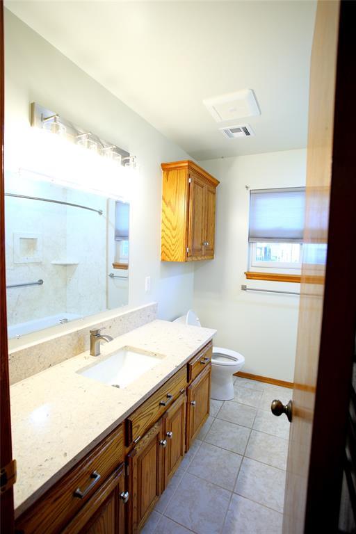 5112 SE 85th St, Oklahoma City, OK 73135 - full bathroom with tile patterned floors, vanity, baseboards, toilet, and visible vents