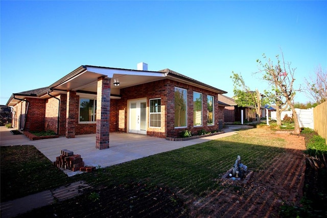 5112 SE 85th St, Oklahoma City, OK 73135 - back of property featuring a chimney, fence, a patio, a lawn, and brick siding