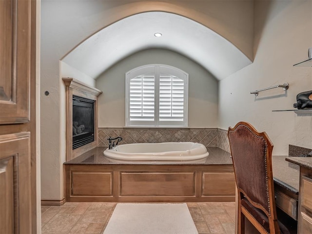 12304 N St Lukes Ln, Oklahoma City, OK 73142 - full bathroom with a garden tub, lofted ceiling, and stone finish flooring