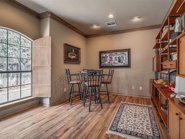 12304 N St Lukes Ln, Oklahoma City, OK 73142 - dining room featuring crown molding, wood finished floors, and baseboards