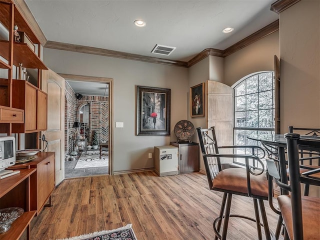 12304 N St Lukes Ln, Oklahoma City, OK 73142 - dining room featuring crown molding, wood finished floors, and baseboards
