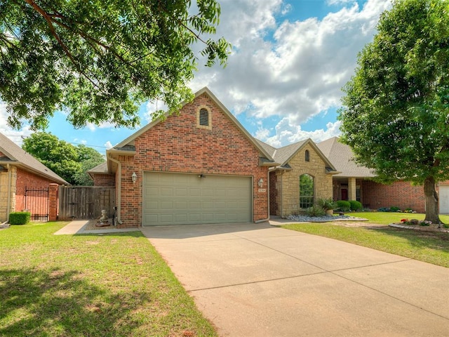 12304 N St Lukes Ln, Oklahoma City, OK 73142 - view of front of home with an attached garage, driveway, stone siding, and brick siding
