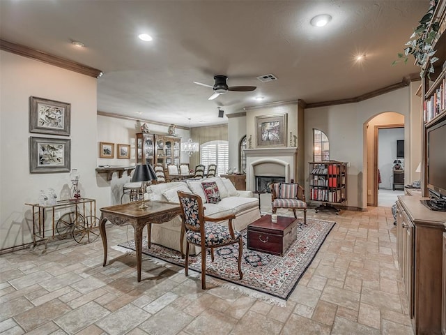 12304 N St Lukes Ln, Oklahoma City, OK 73142 - living area featuring ceiling fan, arched walkways, ornamental molding, stone tile floors, and recessed lighting