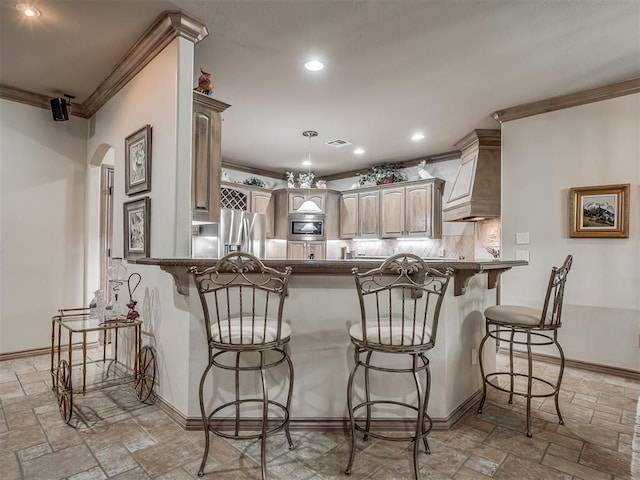 12304 N St Lukes Ln, Oklahoma City, OK 73142 - kitchen featuring stone tile floors, stainless steel appliances, a peninsula, crown molding, and decorative backsplash