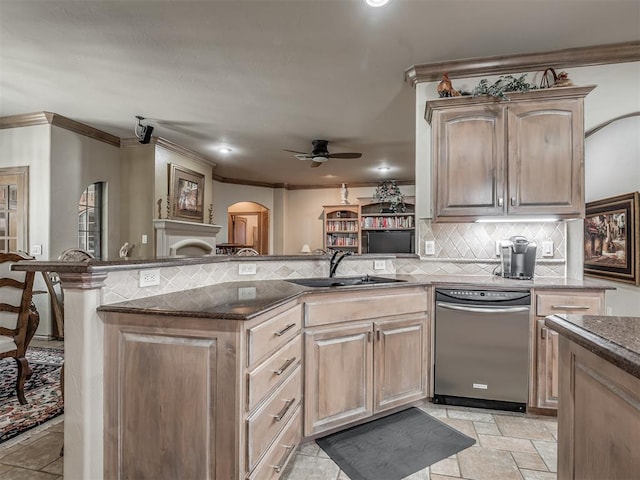 12304 N St Lukes Ln, Oklahoma City, OK 73142 - kitchen featuring a sink, a ceiling fan, arched walkways, dark stone countertops, and crown molding