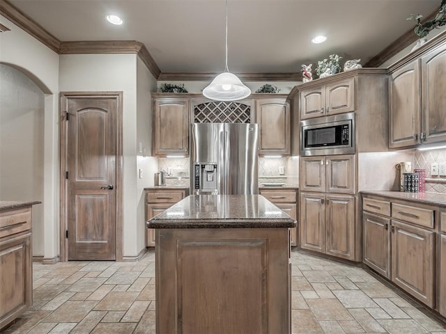 12304 N St Lukes Ln, Oklahoma City, OK 73142 - kitchen featuring appliances with stainless steel finishes, stone tile flooring, ornamental molding, a kitchen island, and decorative backsplash