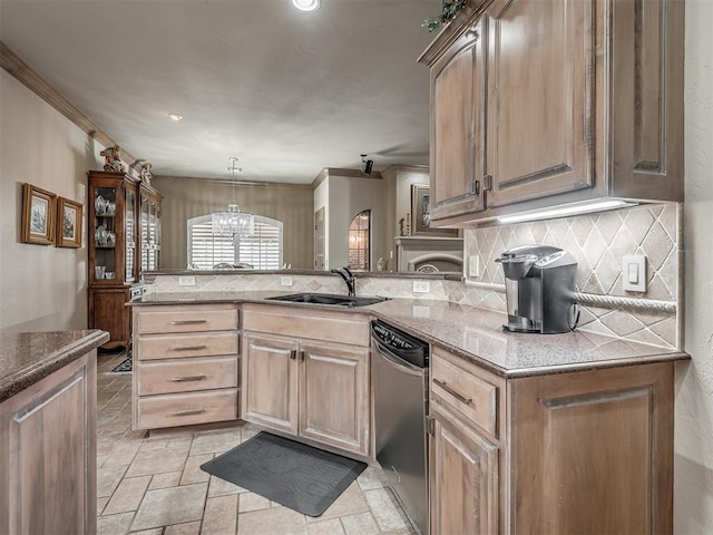 12304 N St Lukes Ln, Oklahoma City, OK 73142 - kitchen featuring a sink, dishwasher, decorative backsplash, a chandelier, and a peninsula