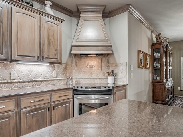 12304 N St Lukes Ln, Oklahoma City, OK 73142 - kitchen featuring stainless steel electric range, custom range hood, crown molding, dark stone counters, and tasteful backsplash