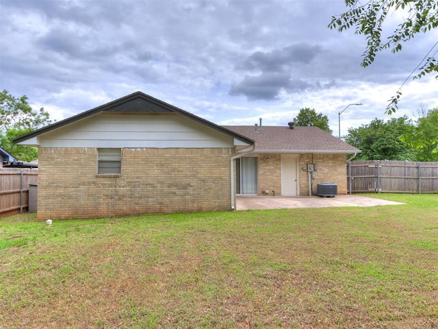 1703 Surrey Pl, Norman, OK 73071 - rear view of house featuring a patio, cooling unit, brick siding, and a shingled roof