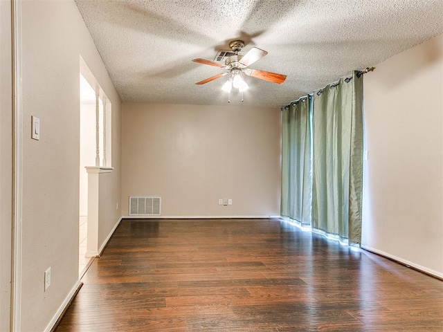 1703 Surrey Pl, Norman, OK 73071 - unfurnished room featuring ceiling fan, wood finished floors, a textured ceiling, baseboards, and healthy amount of natural light